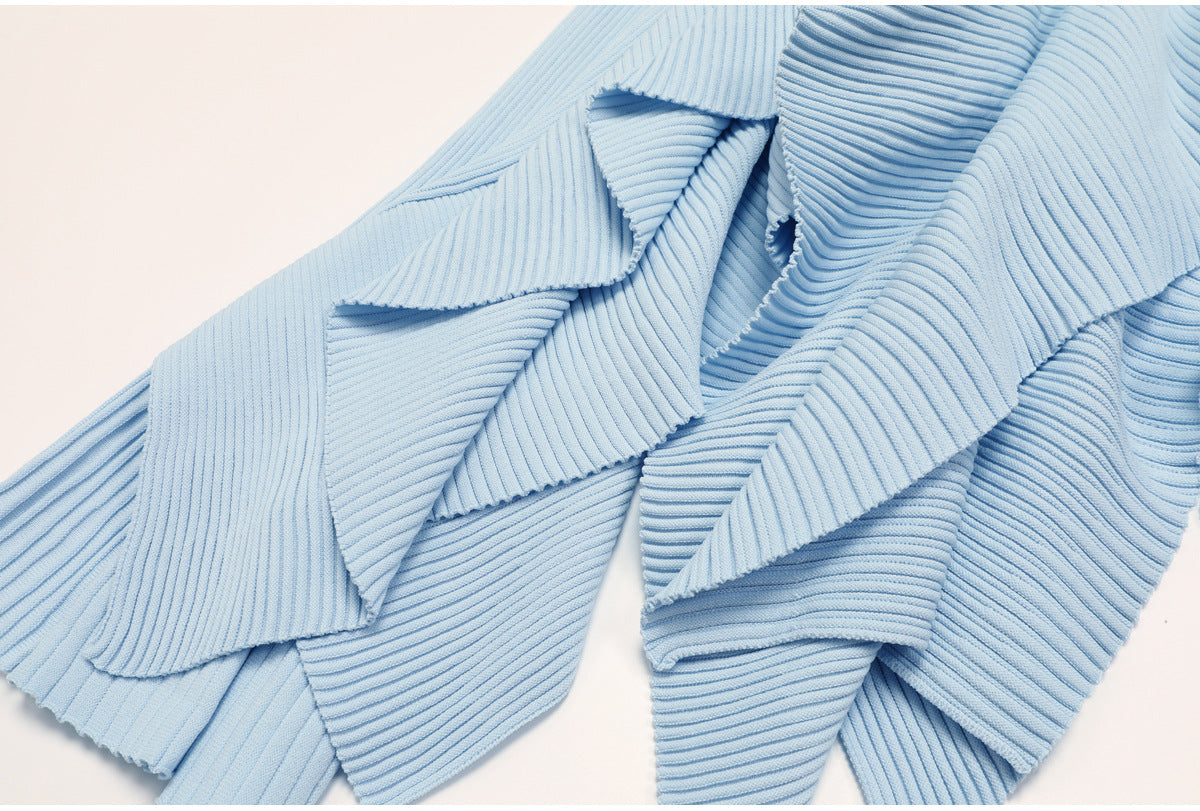 Detailed lower view of pleated blue skirt ruffles
