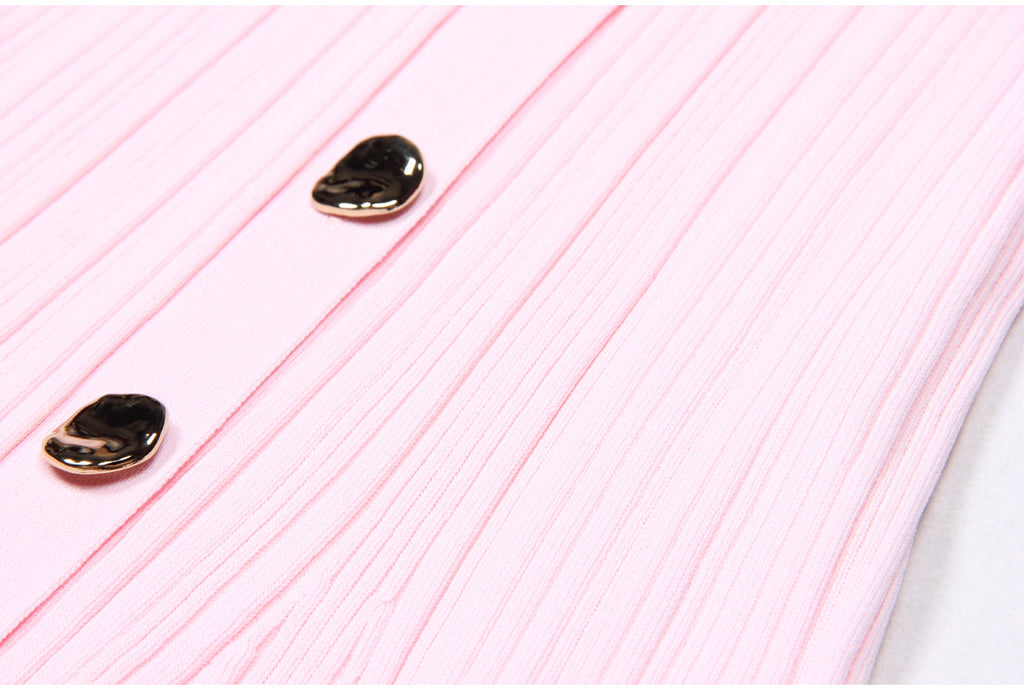 Macro of two metallic buttons on pink dress