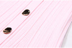 Macro of two metallic buttons on pink dress