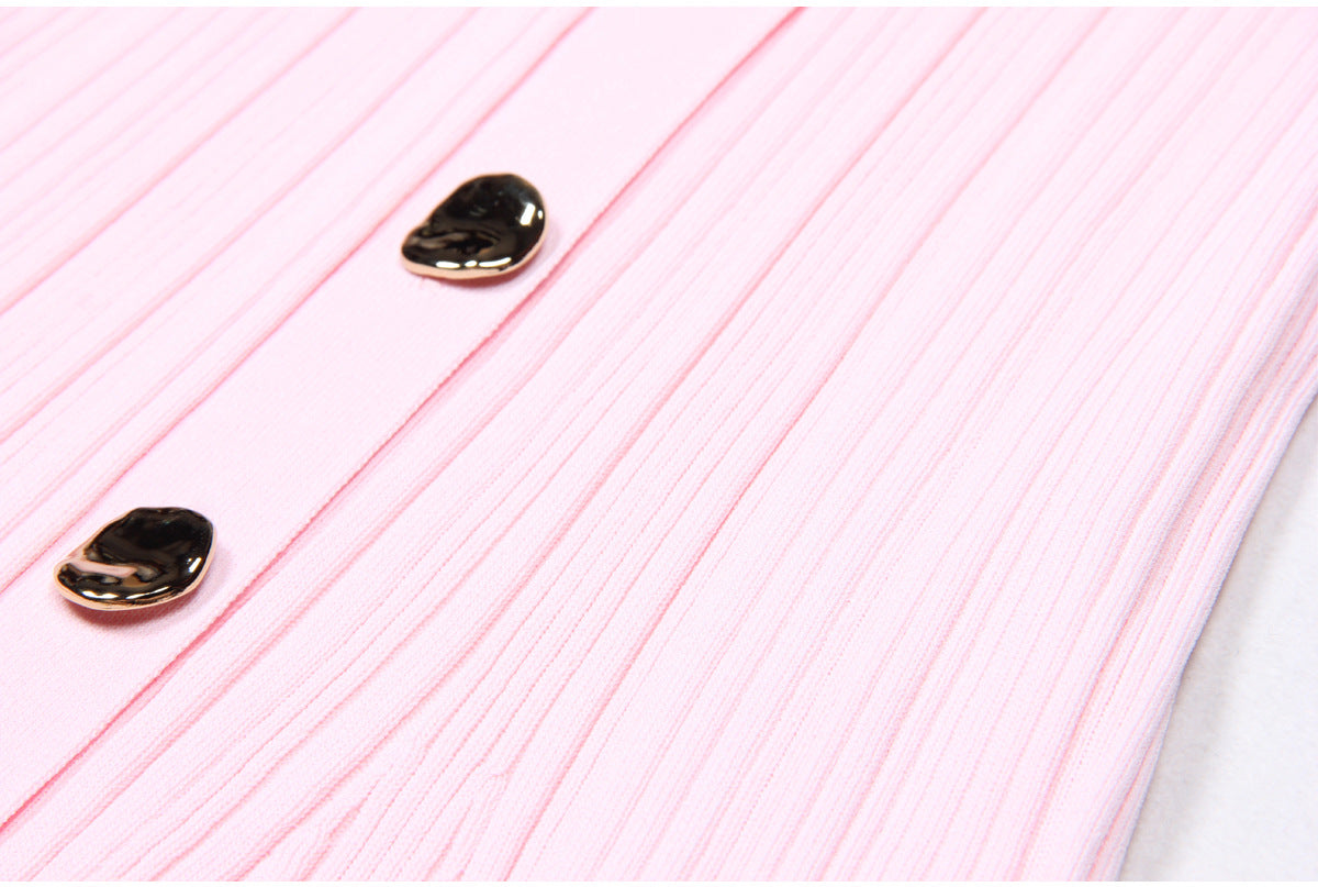 Macro of two metallic buttons on pink dress