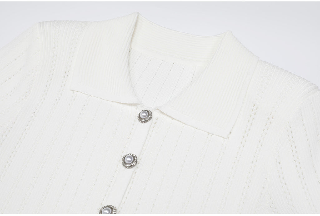 Close-up of white ribbed collar and pearl buttons on dress