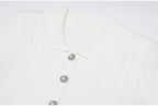 Close-up of white ribbed collar and pearl buttons on dress