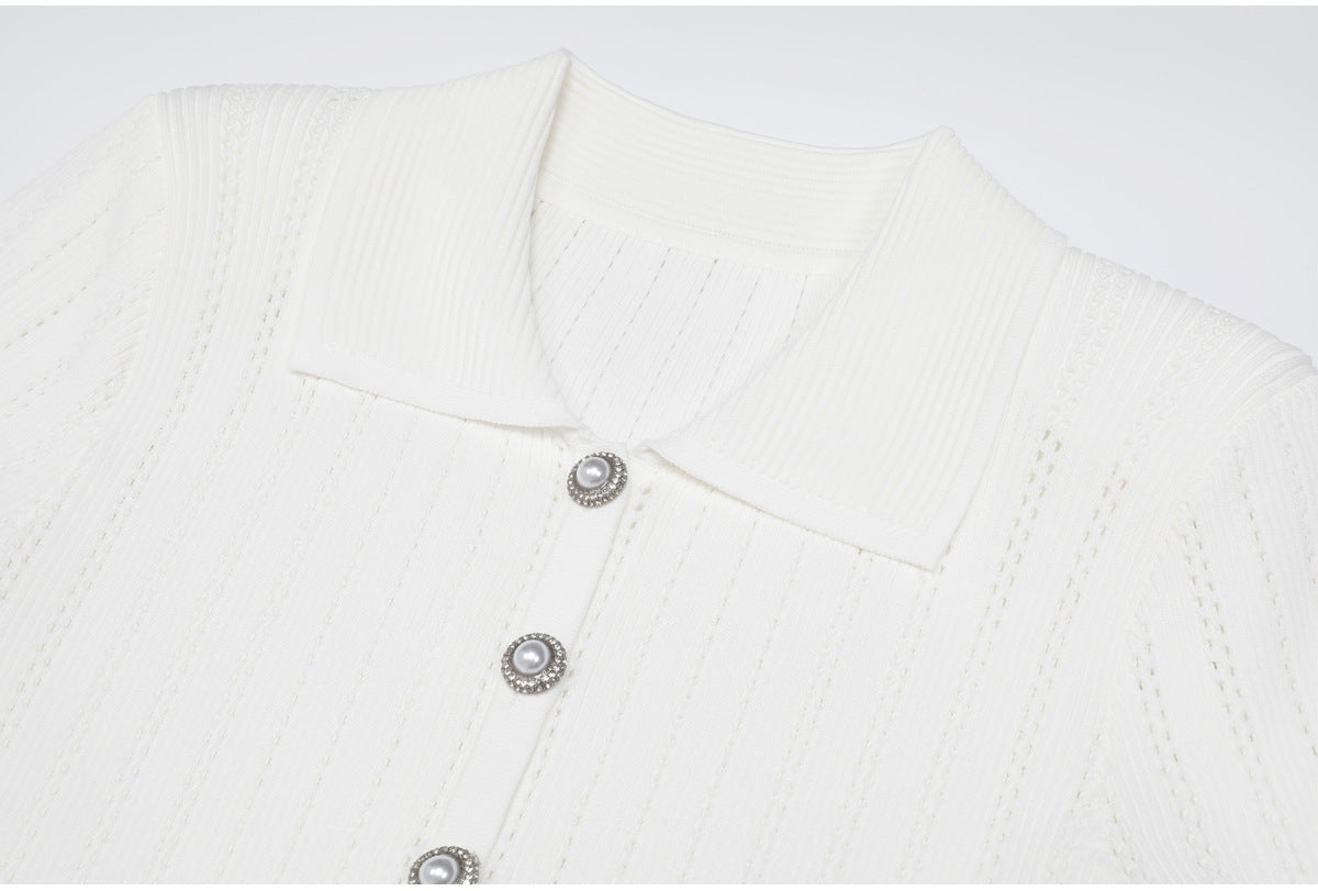 Close-up of white ribbed collar and pearl buttons on dress